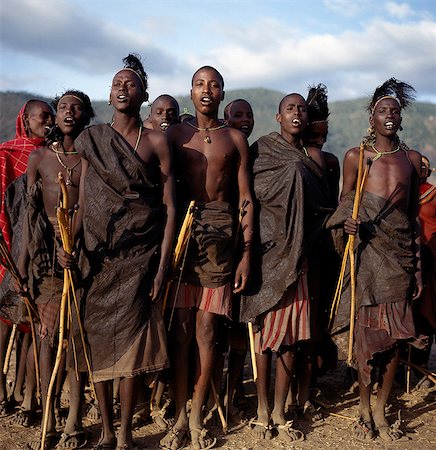 Samburu initiates sing during the month after their circumcision. As their wounds heal, their dances become more energetic. Before long, they imitate the dances of the warriors which, hitherto, they have been forbidden to perform.They spend much of their time wandering in the countryside attempting to kill as many birds as they can with a club and four blunt arrows. When a bird is killed, it is sk Stock Photo - Rights-Managed, Code: 862-03820699