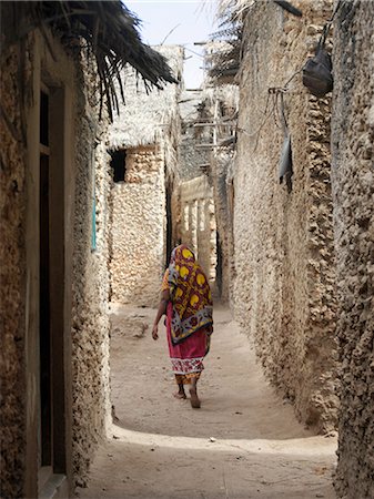 simsearch:862-03820754,k - A typical street scene in one of the poorer areas of Pate Village.All the buildings in Pate are constructed of coral rag with makuti roofs, which are a type of thatch made from coconut palm fronds.Pate was established by Arabs from Arabia in the 13th century, or possibly earlier. Stock Photo - Rights-Managed, Code: 862-03820754