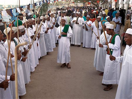 simsearch:862-03366742,k - In the late afternoon, Muslim men perform the Shabuwani along the waterfront at Lamu town during the annual Lamu festival.Situated 150 miles north northeast of Mombasa, Lamu town dates from the 15th century AD. The islands importance lies in the fact that it has the only certain source of sweet groundwater in the entire district. Stock Photo - Rights-Managed, Code: 862-03820773