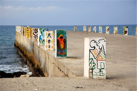 sao tome - A pier in Fernao Dias,  built in 1952 on the island of Sao Tome using forced labour under Governor Gorgulho.Fernao Dias is the only possible location in Sao Tom for a deep sea pier.The designs on the bollards were recently painted by local artists.Sao Tome and Principe is Africas second smallest country with a population of 193 000. Stock Photo - Rights-Managed, Code: 862-03820939