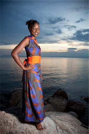 equatorien - A Burundian girl models clothes at sunsest on the shore of lake Tanganyika. Stock Photo - Rights-Managed, Code: 862-03887429