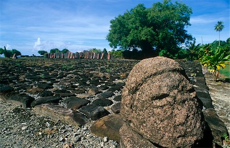 French Polynesia, Society Islands, Leeward Islands, Raiatea, Taputapuatea. Restored in 1994, the marae - a Polynesian sacred or ceremonial site - of Taputapuatea is believed to have been among the regions most important. The humanoid carving, sometimes known as a tiki, probably marks the maraes sacred boundary. Stock Photo - Rights-Managed, Code: 862-03887686