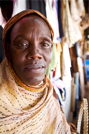 equator - Kigali, Rwanda. An old woman trades traditional clothes in Kimironko market. Stock Photo - Rights-Managed, Code: 862-03889499