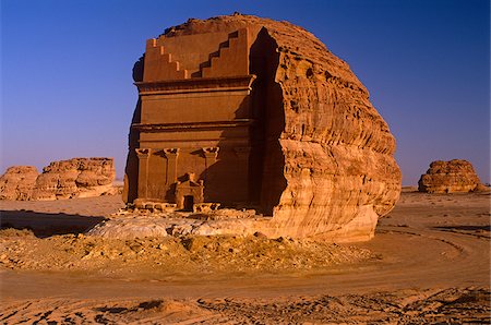 Saudi Arabia, Madinah, nr. Al-Ula, Madain Saleh (aka Hegra). Now a UNESCO World Heritage Site, the ancient remains of Qasr al-Farid - a rock-cut tomb and part of an ancient Nabatean settlement - stands amidst imposing cliffs and striking rocky outcrops. Stock Photo - Rights-Managed, Code: 862-03889524