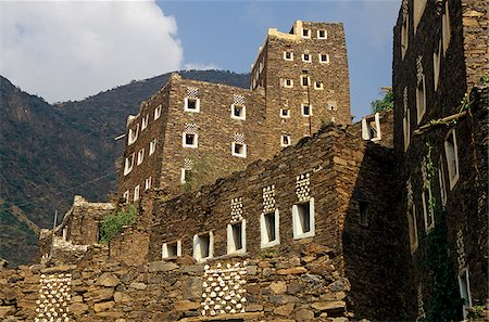 Saudi Arabia, Asir, Rejal- al-amaa. Standing in the Asir Mountains and recently part-restored, the village of Rejal al-Maa's traditional masonry buildings show similarities to the architecture of nearby Yemen. Foto de stock - Con derechos protegidos, Código: 862-03889533