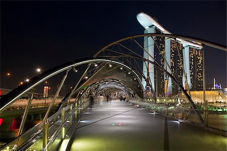 simsearch:862-07690829,k - Singapore, Singapore, Marina Bay.  The Helix Bridge and Marina Bay Sands Singapore.  The hotel complex includes a casino, shopping mall and the ArtScience Museum. Stock Photo - Rights-Managed, Code: 862-03889573