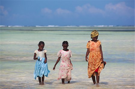 dress wading water - A woman and two children walking along the shallow water of the Indian Ocean in Zanzibar, Tanzania Stock Photo - Rights-Managed, Code: 862-03890080