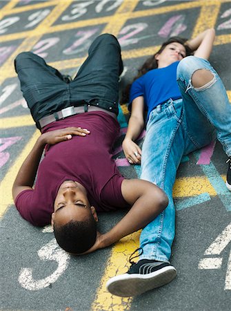 Teenagers lying on the floor Stock Photo - Rights-Managed, Code: 877-06834003