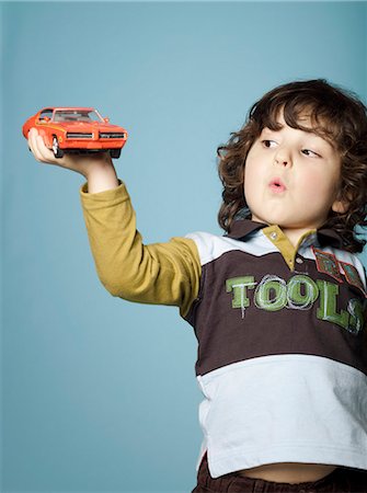 Little boy playing with toy car Stock Photo - Rights-Managed, Code: 877-06834015