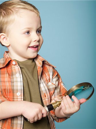 Little boy holding magnifying glass Stock Photo - Rights-Managed, Code: 877-06834027