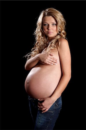 pregnant woman standing white background - Topless pregnant woman with hands covering breast Stock Photo - Rights-Managed, Code: 877-06834278