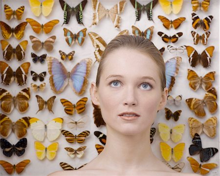 Portrait of young woman by butterfly collection Stock Photo - Rights-Managed, Code: 877-06834313