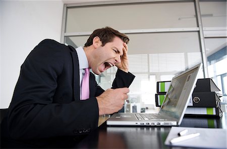 suit yelling - Businessman working on laptop computer Stock Photo - Rights-Managed, Code: 877-06834351