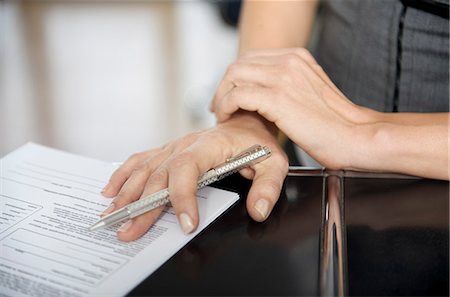 simsearch:877-06832579,k - Close-up of woman's hand filling out a paper Stock Photo - Rights-Managed, Code: 877-06834391
