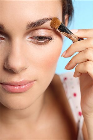 pinceau de maquillage - Young woman applying eyeshadow Photographie de stock - Rights-Managed, Code: 877-06834724