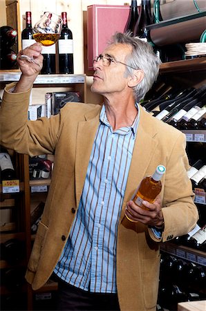 shopping for wine - Man, occidental, selecting a bottle of wine Stock Photo - Rights-Managed, Code: 877-06835435