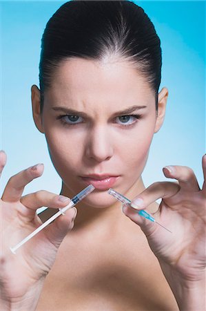 simsearch:877-06836182,k - Young woman frowning, with broken syringe Stock Photo - Rights-Managed, Code: 877-06836284