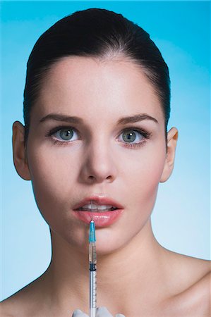 simsearch:877-06836256,k - Young woman with syringe on lips Foto de stock - Con derechos protegidos, Código: 877-06836280