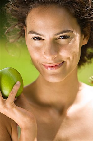 fruit eyes not children - Young woman holding an apple Stock Photo - Rights-Managed, Code: 877-06832176