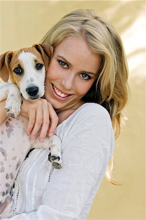 Portrait of a young woman holding a small dog Stock Photo - Rights-Managed, Code: 877-06832379
