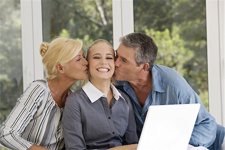 simsearch:877-06832463,k - Mature couple kissing a young woman Foto de stock - Con derechos protegidos, Código: 877-06832440