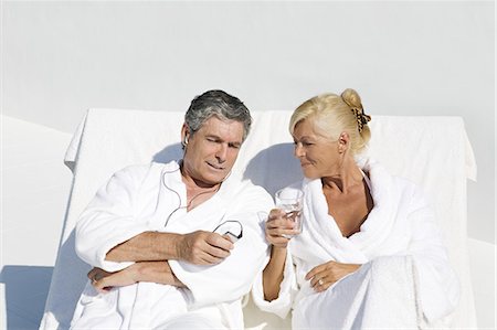 Mature couple wearing bathrobes, sitting on a terrace Stock Photo - Rights-Managed, Code: 877-06832478
