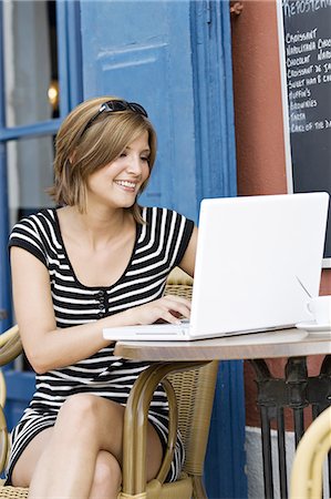 simsearch:877-06835807,k - Young woman sitting at coffee shop terrace, laptop Stock Photo - Rights-Managed, Code: 877-06832509