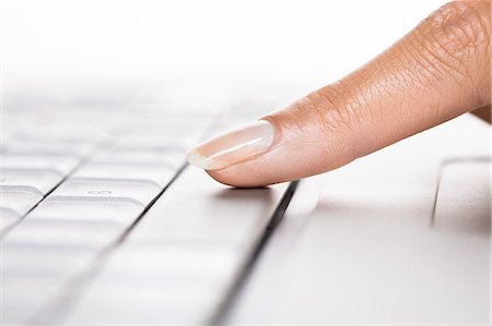 Woman's finger on a laptop Photographie de stock - Rights-Managed, Code: 877-06832559