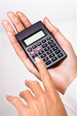 Woman's hands holding a calculator Stock Photo - Rights-Managed, Code: 877-06832574