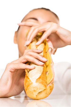 Woman eating a sandwich Photographie de stock - Rights-Managed, Code: 877-06832571