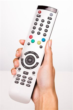 Woman's hand holding a remote control Stock Photo - Rights-Managed, Code: 877-06832572