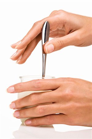 Woman's hands holding a spoon and a yoghurt Stock Photo - Rights-Managed, Code: 877-06832594