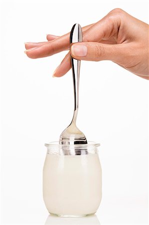 Woman's hand holding a spoon in a yoghurt Stock Photo - Rights-Managed, Code: 877-06832593