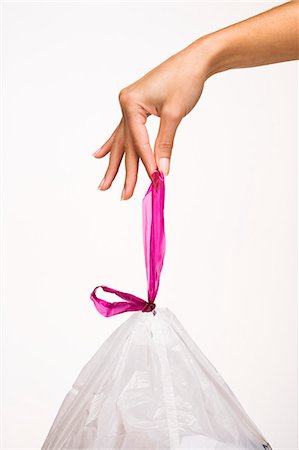 Woman's hand holding a trash bag Photographie de stock - Rights-Managed, Code: 877-06832624