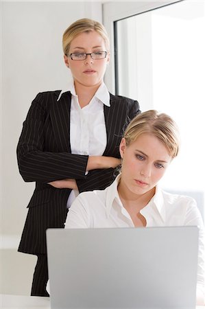 simsearch:877-06834718,k - Businesswoman supervising woman using laptop computer Stock Photo - Rights-Managed, Code: 877-06832743