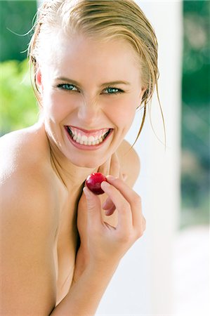 simsearch:877-06836347,k - Portrait laughing woman, holding a cherry Stock Photo - Rights-Managed, Code: 877-06832841