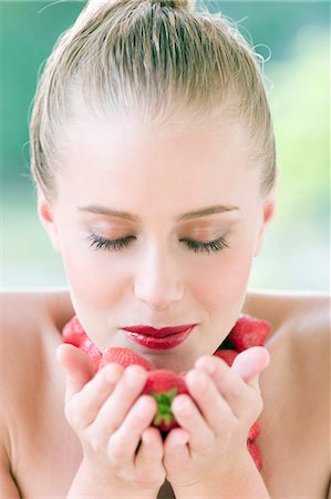 Portrait young woman holding strawberries Stock Photo - Rights-Managed, Code: 877-06832843