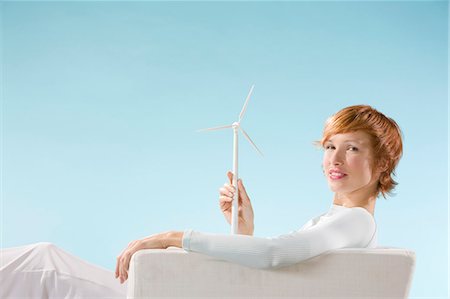 simsearch:400-07712720,k - Woman looking at the camera, éolienne in hand in a clear blue background Stock Photo - Rights-Managed, Code: 877-06832874