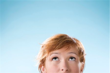 face looking up - Portrait of woman on light blue background Stock Photo - Rights-Managed, Code: 877-06832926