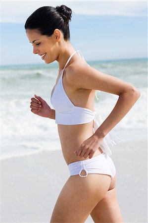 Young woman on the beach, wearing a bathsuit Stock Photo - Rights-Managed, Code: 877-06833107