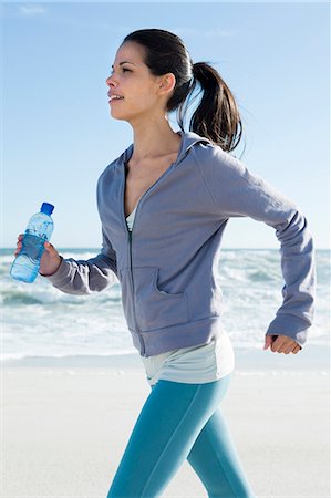running water bottle - Young woman on the beach Stock Photo - Rights-Managed, Code: 877-06833173