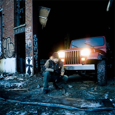 Man in front of a Red 4WD in abandoned shed Stock Photo - Rights-Managed, Code: 877-06833512
