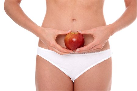 simsearch:877-06833602,k - Woman in underwear holding apple Foto de stock - Con derechos protegidos, Código: 877-06833595