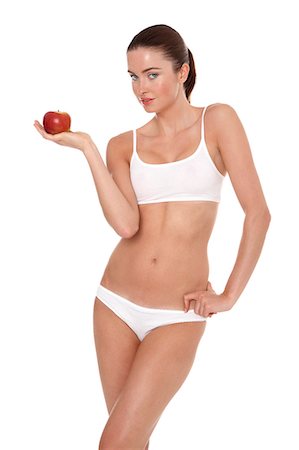 simsearch:877-06833602,k - Woman in underwear holding apple Foto de stock - Con derechos protegidos, Código: 877-06833596