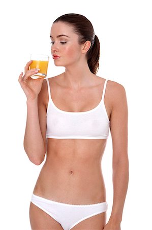 simsearch:877-06833602,k - Woman in underwear, drinking fruit juice Foto de stock - Con derechos protegidos, Código: 877-06833621