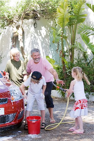 playing with hose - Family washing car Stock Photo - Rights-Managed, Code: 877-06833653