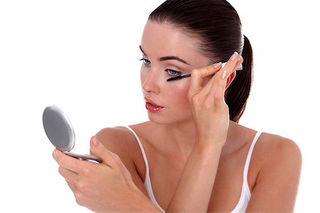 Young woman applying makeup Stock Photo - Rights-Managed, Code: 877-06833722