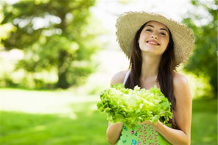 Young woman holding a lettuce Stock Photo - Rights-Managed, Code: 877-06833876
