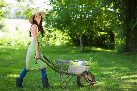 rubber boots grass - Young woman pushing wheelbarrow Stock Photo - Rights-Managed, Code: 877-06833888