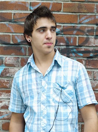 Teenage boy leaning against wall Stock Photo - Rights-Managed, Code: 877-06833916